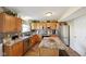 Well-lit kitchen featuring wood cabinets, stainless steel appliances, and a center island for food preparation at 11624 Eldridge Dr, Indianapolis, IN 46235