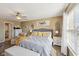 Inviting main bedroom featuring a ceiling fan, a large bed, neutral color walls, and carpeted floors at 11624 Eldridge Dr, Indianapolis, IN 46235