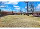 Spacious grassy backyard with brick home, screened porch, storage shed and mature trees at 12 Danridge Dr, Danville, IN 46122