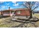 Spacious backyard showcasing a brick home with a screened porch and landscaped patio area at 12 Danridge Dr, Danville, IN 46122
