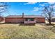 A brick home with a screened-in porch, viewed from the backyard with a clear blue sky above at 12 Danridge Dr, Danville, IN 46122