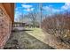 A view of the backyard, complete with a screened porch, trees, and a storage shed at 12 Danridge Dr, Danville, IN 46122