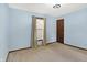 Well-lit bedroom featuring plush carpet, a window with blinds and a wooden door at 12 Danridge Dr, Danville, IN 46122