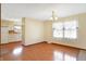 Dining area with hardwood floors, a chandelier, and adjacent kitchen at 12 Danridge Dr, Danville, IN 46122