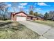 Low angle view of a brick home with an attached garage and long driveway at 12 Danridge Dr, Danville, IN 46122