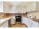 Eat-in kitchen featuring light countertops, white cabinets, and modern stainless steel appliances at 12 Danridge Dr, Danville, IN 46122