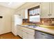 Well-lit kitchen with stainless steel appliances, white cabinetry, and a window over the sink at 12 Danridge Dr, Danville, IN 46122