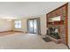 Spacious living room with a brick fireplace, access to the sunroom, and neutral decor at 12 Danridge Dr, Danville, IN 46122