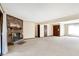 Spacious living room featuring a brick fireplace, neutral paint, and plush carpeting at 12 Danridge Dr, Danville, IN 46122