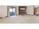 Cozy living room featuring a brick fireplace, access to the sunroom, and hardwood hallway at 12 Danridge Dr, Danville, IN 46122