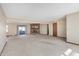 Large living room featuring a brick fireplace, sliding glass door, and neutral carpet at 12 Danridge Dr, Danville, IN 46122