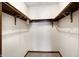 Bright walk-in closet with carpet, wood trim and shelving offering practical storage solutions at 12 Danridge Dr, Danville, IN 46122