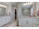 Bathroom featuring a double vanity, large mirrors, and access to walk-in closet and shower at 12073 Springtide Ln, Fishers, IN 46037