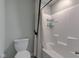 Bathroom with a toilet and a bathtub/shower combination with a white shower curtain at 12073 Springtide Ln, Fishers, IN 46037