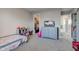 Spacious bedroom with gray walls, carpet, dresser, television, closet, and open doorway at 12073 Springtide Ln, Fishers, IN 46037