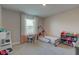 Well-lit bedroom featuring a gray bed, desk, shelves, and carpeted floors at 12073 Springtide Ln, Fishers, IN 46037