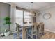 Dining room featuring a stylish light fixture, large window, and neutral tones at 12073 Springtide Ln, Fishers, IN 46037