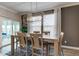 Modern dining room with large windows, natural light, and stylish chandelier for perfect meals at 12073 Springtide Ln, Fishers, IN 46037