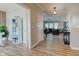 Inviting entryway with wood-look flooring and an open view into the comfortable living room at 12073 Springtide Ln, Fishers, IN 46037