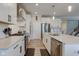 Modern kitchen with stainless steel appliances, white cabinets, and a large island with bar stool seating at 12073 Springtide Ln, Fishers, IN 46037