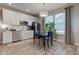 Modern kitchen with stainless appliances, white cabinetry, and adjacent dining area for entertaining at 12073 Springtide Ln, Fishers, IN 46037