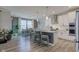 Open kitchen with white cabinets, stainless appliances, and a view to the breakfast nook with seating at 12073 Springtide Ln, Fishers, IN 46037
