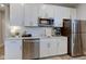 Modern kitchen features white cabinets, stainless steel appliances, and quartz countertops at 12073 Springtide Ln, Fishers, IN 46037