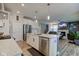 Spacious kitchen island with stainless steel dishwasher and sink, with an open concept to the living room at 12073 Springtide Ln, Fishers, IN 46037