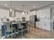 Modern kitchen with white cabinets, stainless steel appliances, and a breakfast bar at 12073 Springtide Ln, Fishers, IN 46037