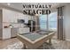 Bright kitchen featuring modern stainless steel appliances and a pool table at 12073 Springtide Ln, Fishers, IN 46037