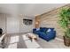 Cozy living room with blue sofa, and a wood panel accent wall at 12073 Springtide Ln, Fishers, IN 46037