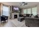 Cozy living room with a fireplace, plush seating, and large windows at 12073 Springtide Ln, Fishers, IN 46037