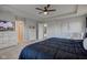 Spacious main bedroom featuring a ceiling fan, television, dresser, and an upholstered chair at 12073 Springtide Ln, Fishers, IN 46037