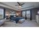 Luxurious main bedroom with a tray ceiling, dark bedding, and side tables at 12073 Springtide Ln, Fishers, IN 46037