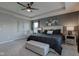 Elegant main bedroom with a tray ceiling, neutral color scheme and soft lighting at 12073 Springtide Ln, Fishers, IN 46037