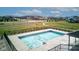 Aerial view of a community pool surrounded by a fence and lush landscaping near neighborhood homes at 12073 Springtide Ln, Fishers, IN 46037