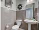 Stylish powder room featuring tiled walls, modern fixtures, and decorative accents for guests at 12073 Springtide Ln, Fishers, IN 46037