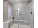 Shower with glass door and gray tiling, complete with a built-in bench at 12073 Springtide Ln, Fishers, IN 46037