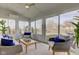 Bright sunroom with comfortable seating and views of the backyard at 12073 Springtide Ln, Fishers, IN 46037