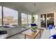 Relaxing sunroom filled with natural light, cozy furniture, and great backyard views at 12073 Springtide Ln, Fishers, IN 46037