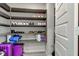 Organized walk-in closet with shelving for shoes and additional storage for luggage at 12073 Springtide Ln, Fishers, IN 46037