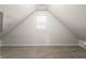 Attic bedroom with a slanted roof, a window, neutral walls, and carpet at 1211 W 30Th St, Indianapolis, IN 46208