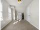 Bright bedroom with light-colored walls, carpet, window, closet, and a sliding door at 1211 W 30Th St, Indianapolis, IN 46208