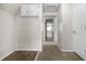Hallway featuring neutral walls, an attic access point, and carpet flooring leading to a naturally lit room at 1211 W 30Th St, Indianapolis, IN 46208