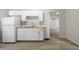 Kitchen featuring white cabinets, laminate countertops and vinyl floors at 1211 W 30Th St, Indianapolis, IN 46208