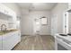 Spacious kitchen featuring white cabinets, laminate countertops and vinyl floors at 1211 W 30Th St, Indianapolis, IN 46208
