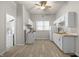 Bright kitchen with white cabinets, laminate countertops and vinyl floors at 1211 W 30Th St, Indianapolis, IN 46208