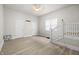 Large living room with staircase, vinyl flooring, and neutral colored walls at 1211 W 30Th St, Indianapolis, IN 46208