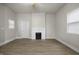 Spacious living room featuring neutral walls, updated flooring, and a cozy fireplace at 1211 W 30Th St, Indianapolis, IN 46208