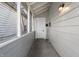 Covered front porch featuring a white door, gray wood and an outdoor light at 1211 W 30Th St, Indianapolis, IN 46208